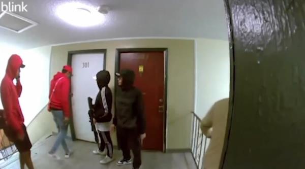 A group of armed men from the Venezuelan transnatio<em></em>nal gang Tren de Aragua standing in a Colorado apartment building hallway