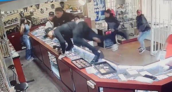 Homeland Security Investigations special agents in store during the custody handover of a Venezuelan gang member, suspect in Denver jewelry heist