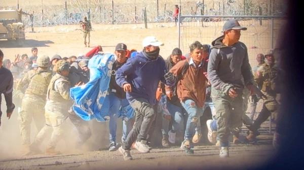 Migrants storm border in El Paso after breaking through border wire and attacking Natio<em></em>nal Guard troops