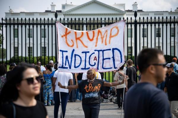 Protesters hold up a sign against Do<em></em>nald Trump outside the White House on June 9, 2023.
