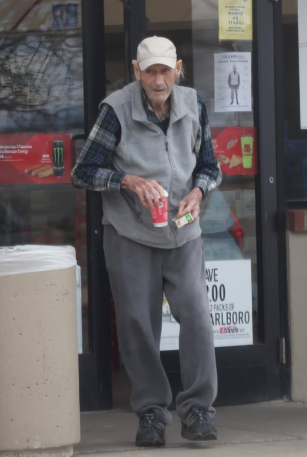 Gene Hackman carrying coffee. 