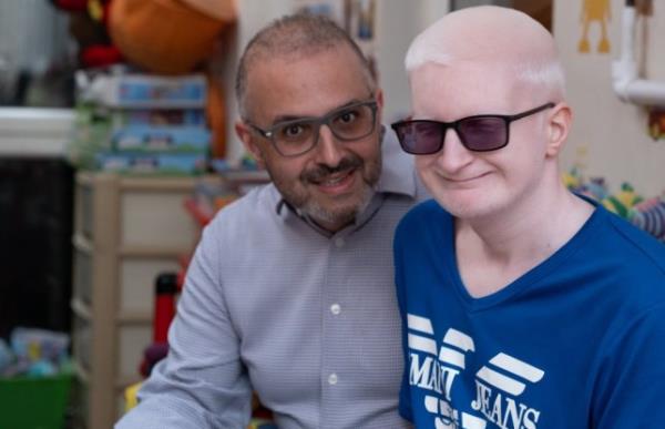 Saeed Ahmed on left with his son, Azhar. Both are wearing glasses and smiling