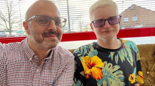 Saeed Ahmed on left with his son, Azhar, right. Both are wearing glasses and smiling