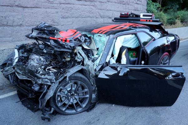 Damaged pickup and Dodge sedan with red stripes involved in a fatal accident on Henry Hudson Parkway