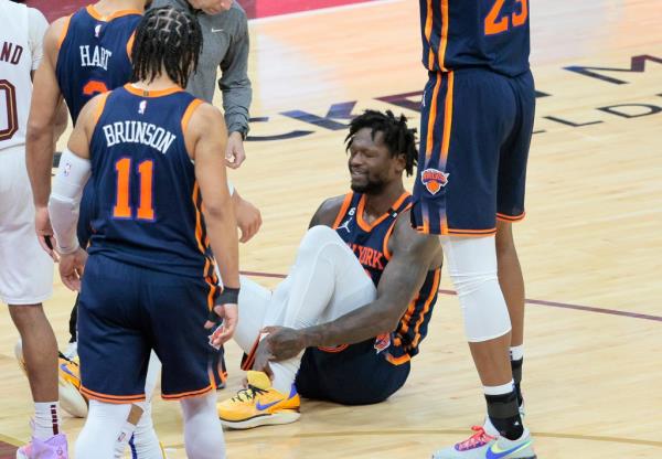 Julius Randle #30 of the New York Knicks on the floor grabbing his ankle after he landed wrong