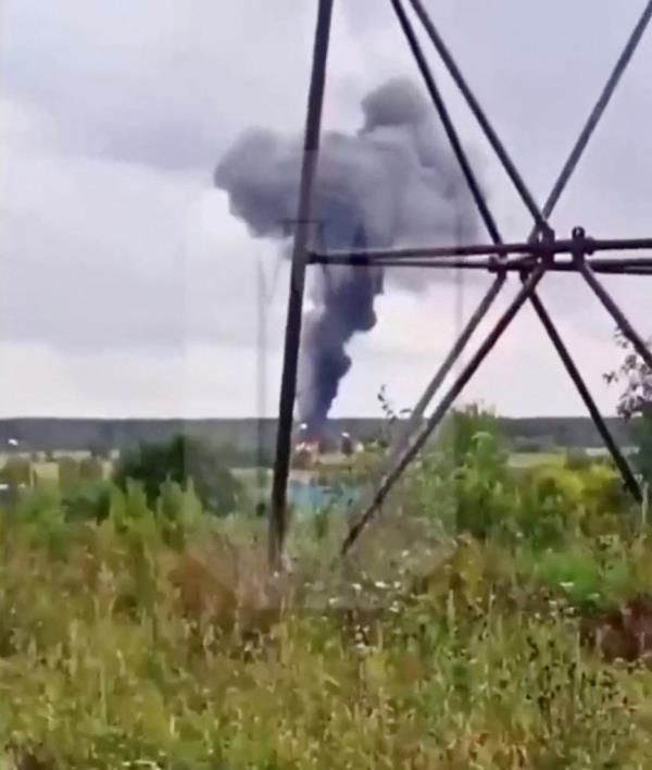 A view shows smoke rising above a plane on fire following an alleged air accident at a location given as Tver region, Russia