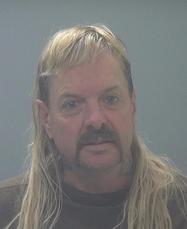 Tiger King star Joe Exotic rocks a lo<em></em>nger mullet in his new prison booking photo.