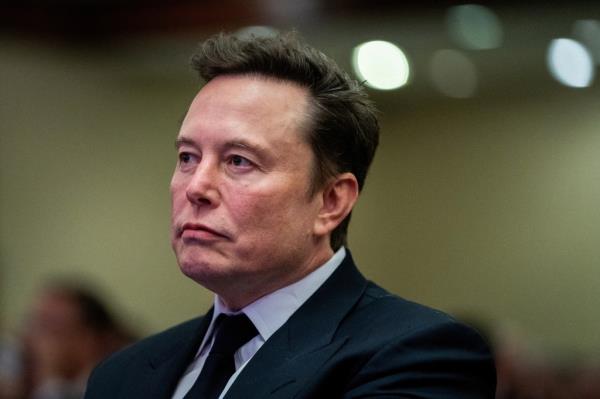 Elon Musk listens as President-elect Do<em></em>nald Trump speaks during meeting with House Republicans on Nov. 13, 2024.