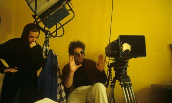 Tehran, Iran: Dariush Mehrjui, renowned Iranian director, during a break while directing 'The Pear Tree', on location in Tehran, 1st February 1999. A veiled female assistant stands next to him. (Photo by Kaveh Kazemi/Getty Images)