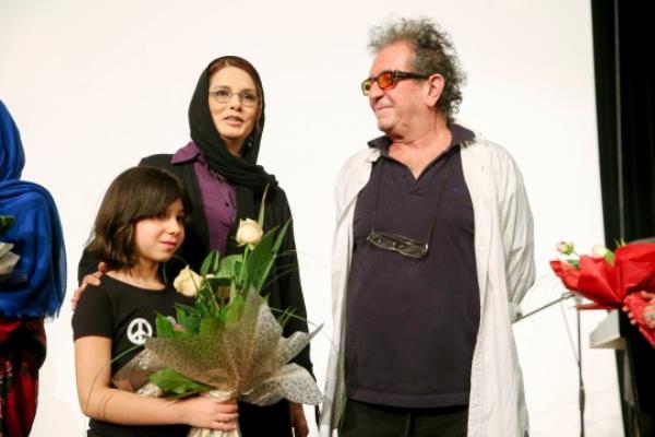 In this photo taken on June 16, 2013, and provided by the Iranian Students' News Agency, ISNA, Iranian film director Dariush Mehrjui and his wife Vahideh Mohammadifar and their daughter Mona stand on stage during a private movie screening in Tehran, Iran. Noted Iranian film director Dariush Mehrjui and his wife were stabbed to death in their home by an unknown assailant, state media reported Sunday, Oct. 15, 2023. (Amir Kholousi, ISNA via AP)