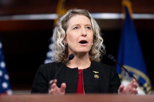 Rep. Jen Kiggans, R-Va., speaking into micropho<em></em>nes at the Bipartisan Defending Borders, Defending Democracies Act news co<em></em>nference in the U.S. Capitol.