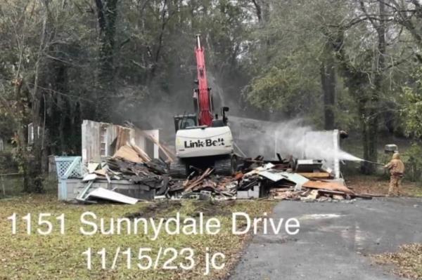 The demolition is part of the county’s plan to remove dangerous structures from neighborhoods.
