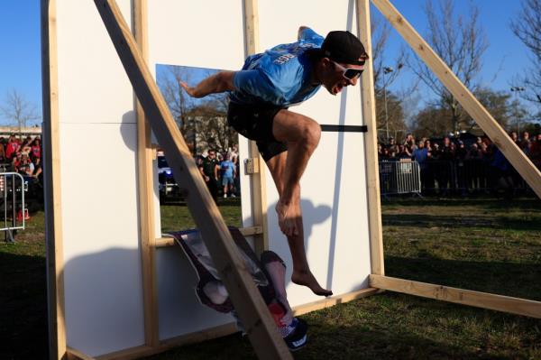 Shane Brennan, of Atlantic Beach, explodes through a barrier in the 