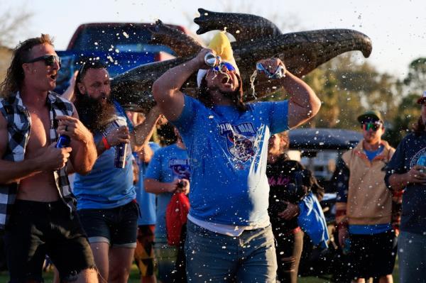 Larry Donnelly, of St. Augustine, double-fists two beers as team 