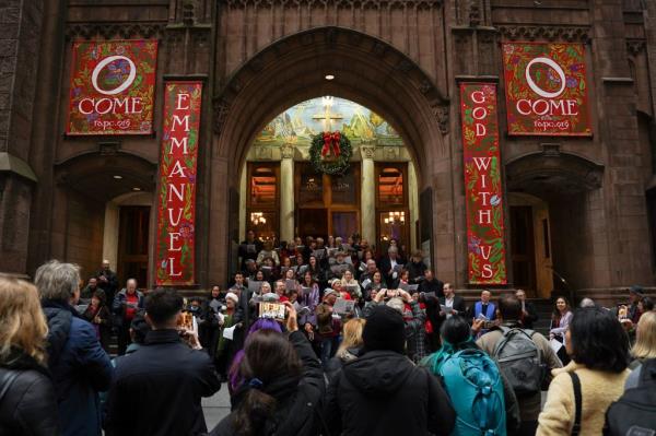 Pedestrians watching a Christmas carol co<em></em>ncert on Fifth Avenue on Dec. 17, 2023.