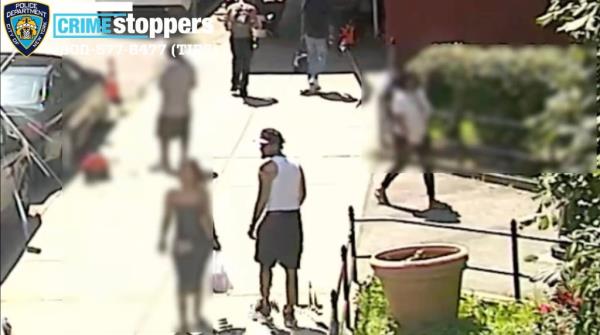 The suspect is seen at the scene of the attack at Aqueduct Avenue and West 183rd Street in University Heights around 2:50 p.m. Thursday.