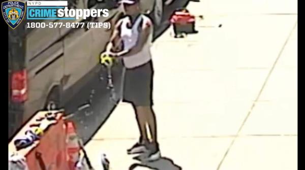 The suspect wrings out a washcloth near the scene of the University Heights attack.