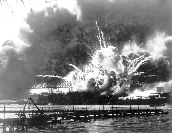 The Navy destroyer USS Shaw explodes after being hit by bombs dropped by Japanese planes during the attack on Pearl Harbor.
