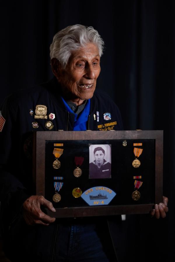 Pearl Harbor Navy veteran Bob Fernandez posing with his military service medals in Lodi, California on November 19, 2024