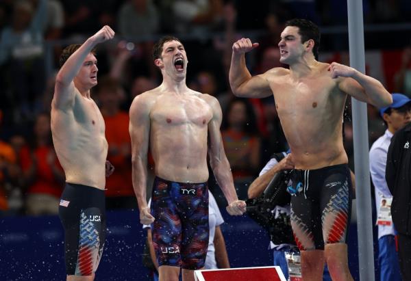 Gold medallists USA's Caeleb Dressel, USA's Hunter Armstrong, USA's Chris Guiliano and USA's Jack Alexy celebrate following the final of the men's 4x100m freestyle relay swimming on day one of the Olympic Games Paris 2024 at Paris La Defense Arena on July 27, 2024 in Nanterre, France.