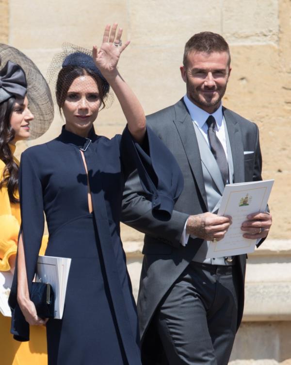 David Beckham and Victoria Beckham attending Prince Harry and Meghan Markle's wedding at Windsor Castle, England, waving to the crowd
