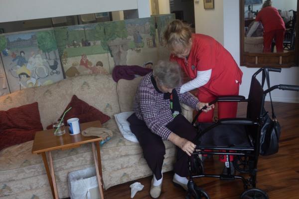 Cynthia Crawford, 90, receives help from a home health care nurse in her own apartment in an assisted living facility on September 13, 2024 in Sarasota, Florida.