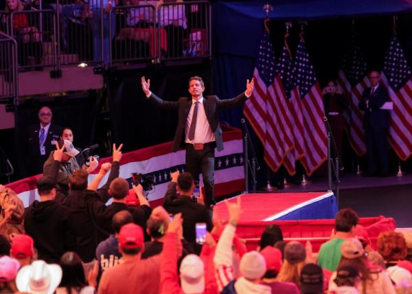 Comedian Tony Hinchcliffe walking on stage at Do<em></em>nald Trump's rally in Madison Square Garden, New York, arms raised, on October 27, 2024