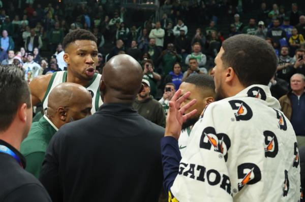 : Giannis Antetokounmpo #34 of the Milwaukee Bucks exchanges words with Tyrese Haliburton #0 of the Indiana Pacers following a game at Fiserv Forum on December 13, 2023