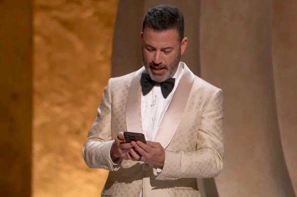 Jimmy Kimmel reading his phone at the Oscars.