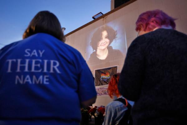 Community members gather at a candlelight vigil in City Park on Mo<em></em>nday to ho<em></em>nor the life of and grieve the death of Nex Benedict.