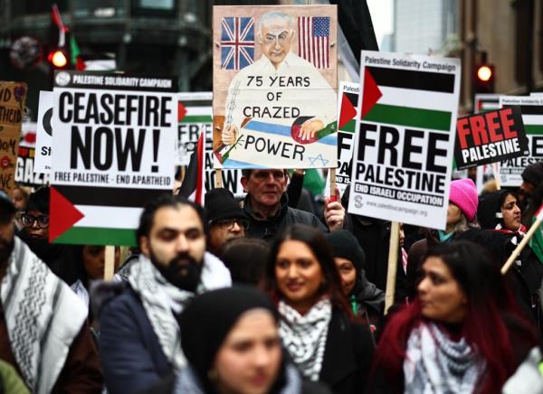 Pro-Palestinian activists and supporters wave flags and carry placards during a Natio<em></em>nal March for Palestine in central Lo<em></em>ndon on January 13, 2024.