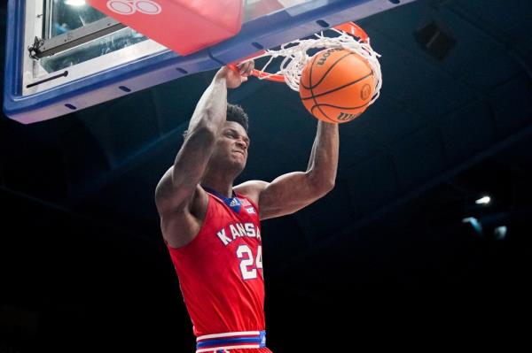 Jayhawks guard Kevin McCullar Jr. (15) dunks the ball against the Kansas State Wildcats.