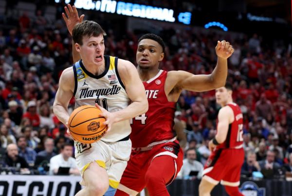 Golden Eagles guard Tyler Kolek (11) drives against North Carolina State Wolfpack guard Casey Morsell