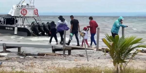 Migrants boarding a boat in Colombia to head to the Darien Gap.
