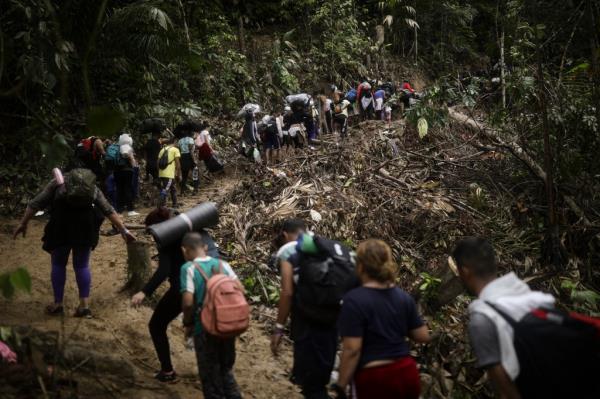 Migrants walking along a jungle path while traveling from Colombia to Panama on May 9, 2024.