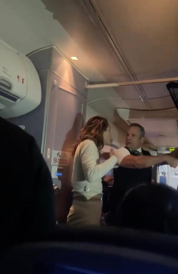 The flight attendants yelled at her to sit down, but the woman kept refusing and dared them to land the plane.