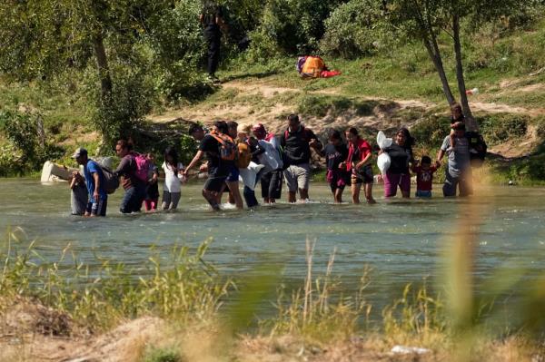 Migrants cross the Rio Grande from Mexico into the U.S., Thursday, Sept. 21, 2023, in Eagle Pass, Texas. 