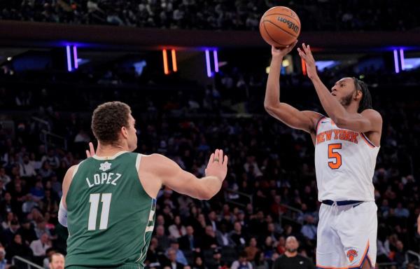 New York Knicks guard Immanuel Quickley #5 puts up a shot as Milwaukee Bucks center Brook Lopez #11 is too late to defend during the fourth quarter.