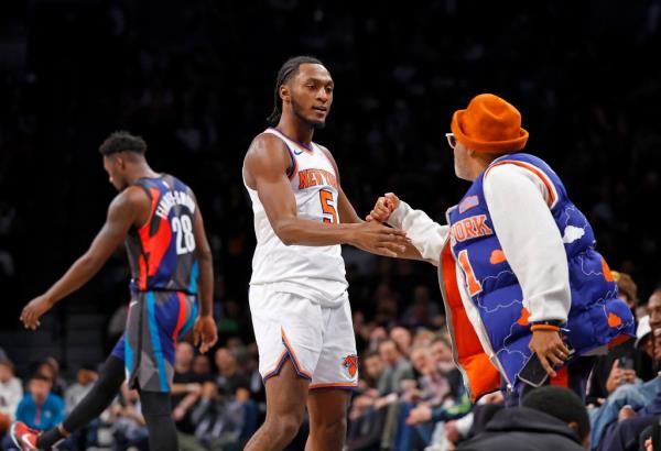 Immanuel Quickley #5 of the New York Knicks is greeted by Spike Lee