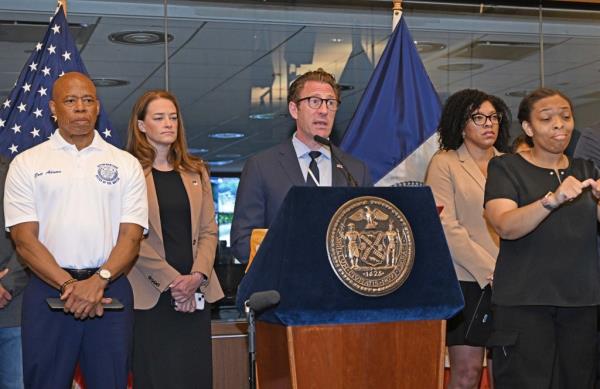 Zach Iscol addressing at a press co<em></em>nference a<em></em>bout the upcoming heat wave in NYC, with Mayor Adams and other officials in the background