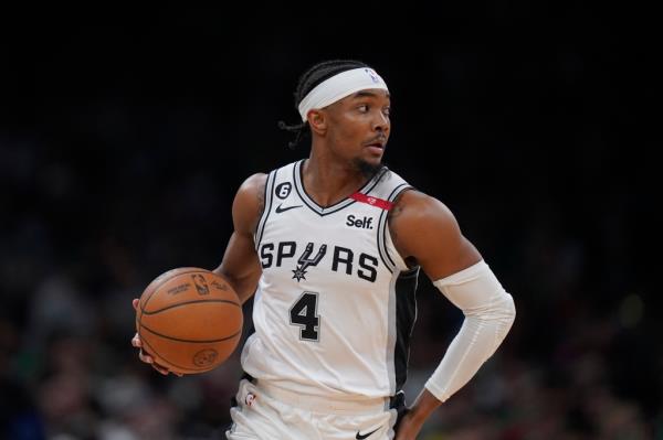 Spurs guard Devonte' Graham runs with the ball during the second half of an NBA basketball game
