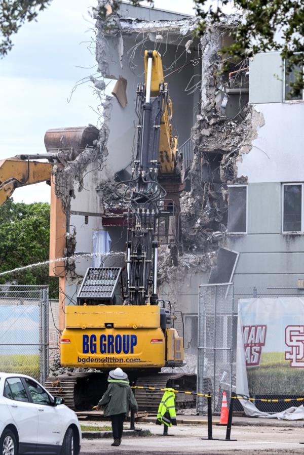 Co<em></em>nstruction crews beginning the demolition of Marjory Sto<em></em>neman Douglas High School building in Parkland, Florida, a site of a 2018 mass shooting.