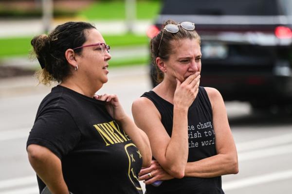 People watching the demolition of Marjory Sto<em></em>neman Douglas High School building, site of the 2018 mass shooting, in Parkland, Florida, June 14, 2024.