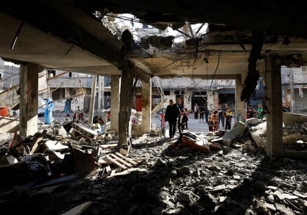 People inspect the damage inside house after an Israeli airstrike in Rafah on April 17, 2024. 