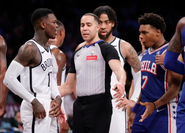 Referee Jo<em></em>nathan Sterling separates Nets guard Dennis Schroder, left, and 76ers guard Kyle Lowry, right, during the first half on Tuesday night. 