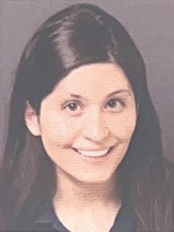 Ariel Roman in an undated mugshot, smiling with long hair