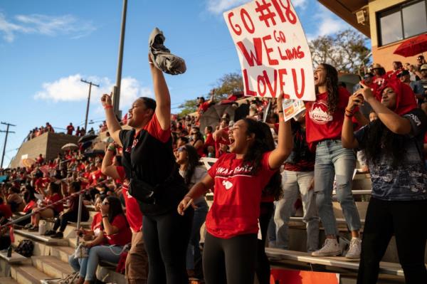 Lahainaluna High School students cheer for the varsity football team during their homecoming game at Sue D. Cooley Stadium, Saturday, Oct. 21, 2023, in Lahaina, Hawaii.