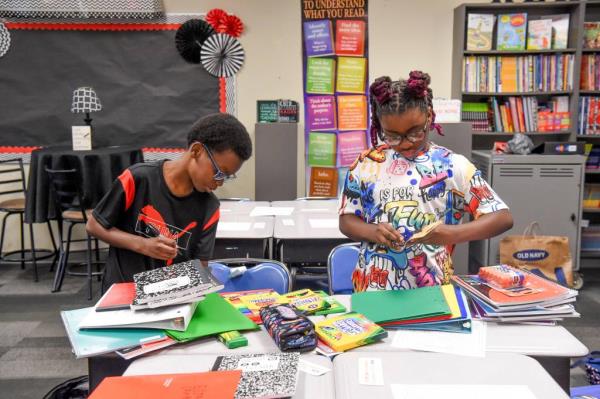 Gabriel Cook and Avery Dodson sort out and label their school supplies at University Place Elementary during the first day of class for Tuscaloosa City Schools Wednesday, Aug. 7, 2024.