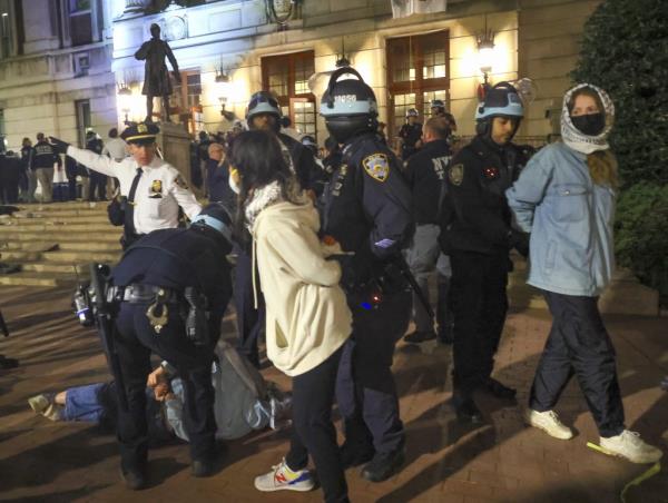 NYPD officers detain dozens of pro-Palestinian students at Columbia University after they barricaded themselves at the Hamilton Hall building.