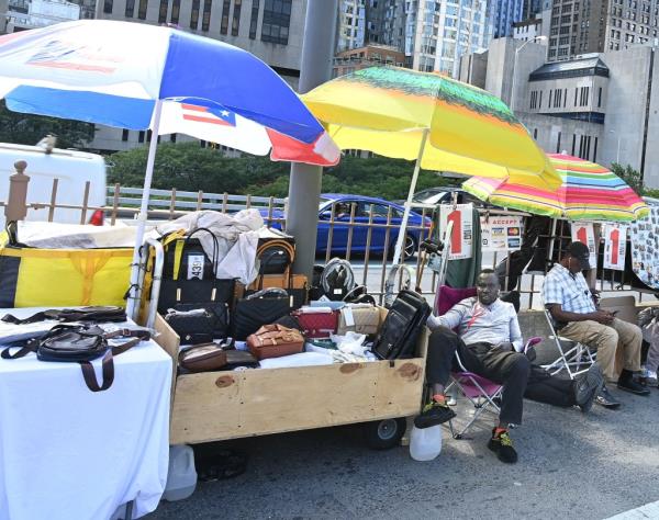 Vendors selling bags on the Brooklyn Bridge.